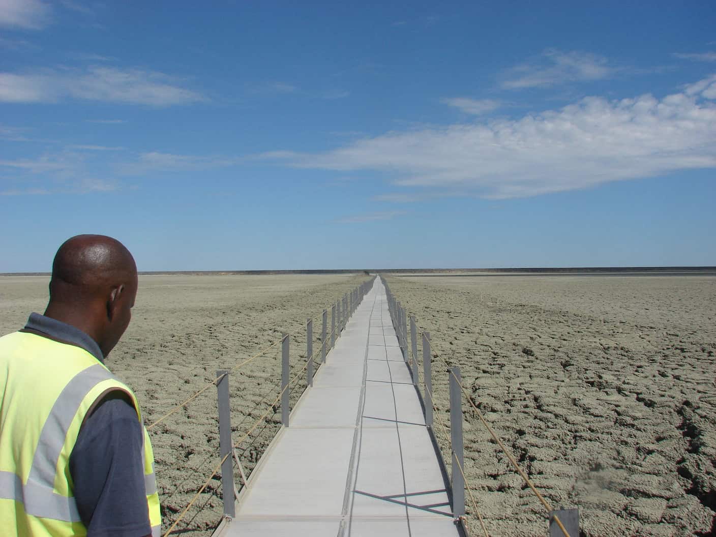 Long Xrosswater walkway across a dry diamond tailings dam in Botswana