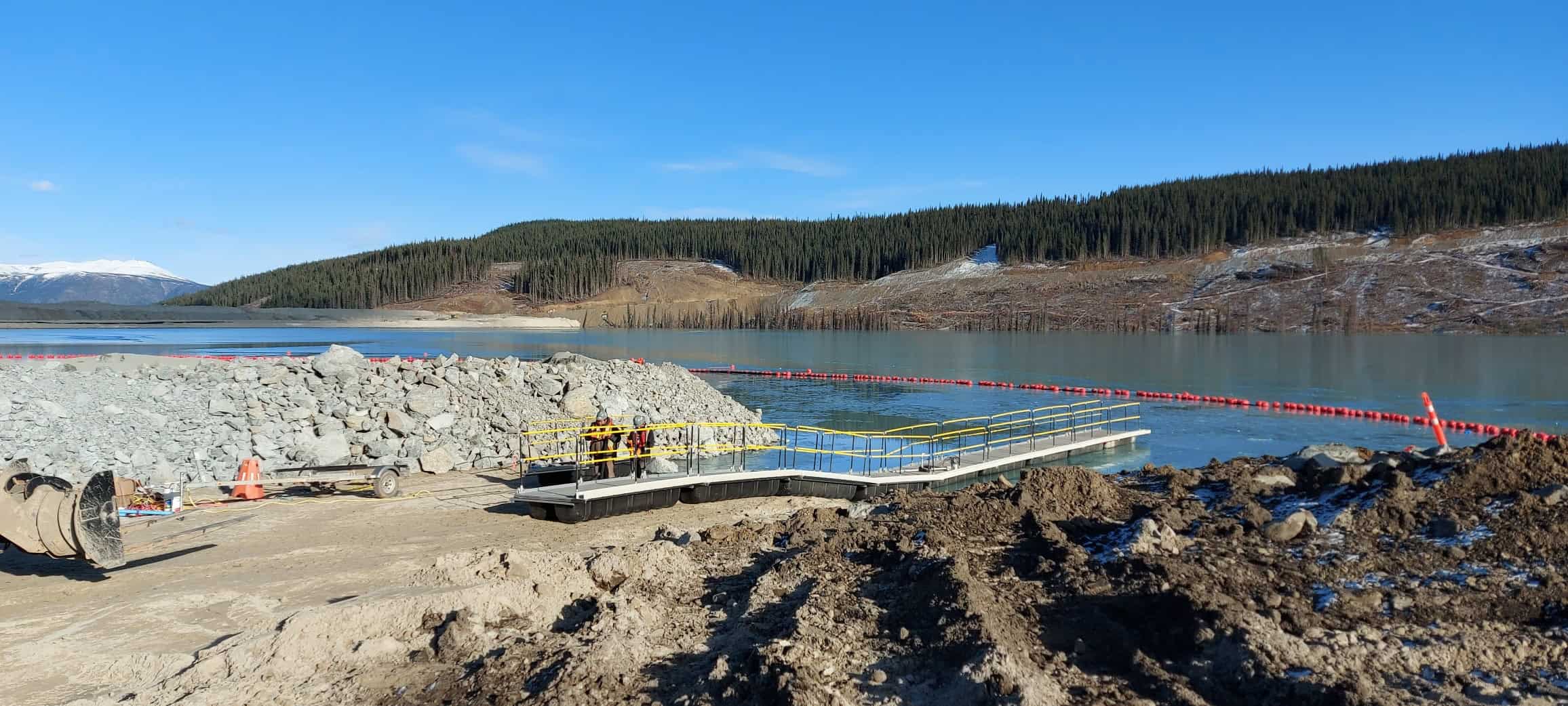 Xrosswater walkway with yellow handrails and life vest sign on open water